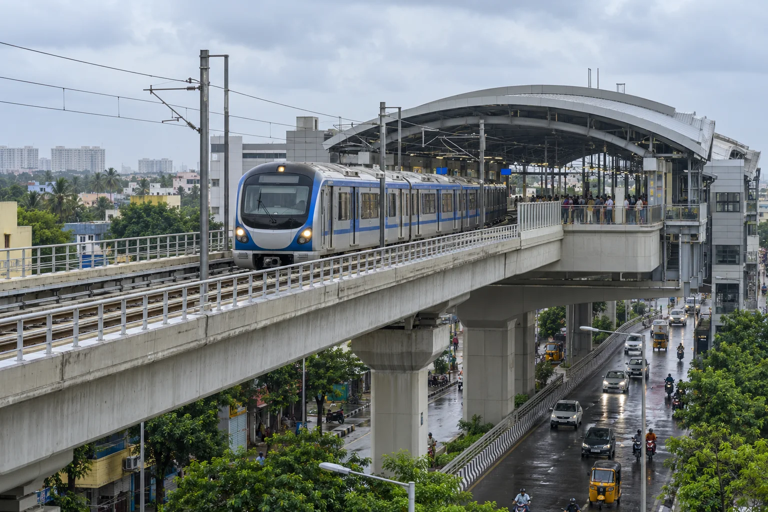 Modern elevated metro train approaching a western Chennai station after light rain