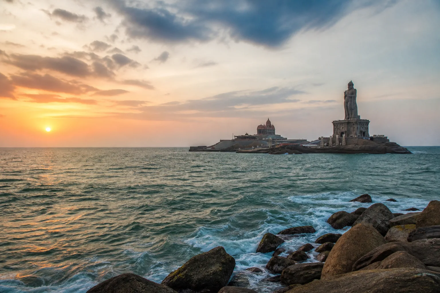 Editorial sunrise view of Kanyakumari seafront and offshore memorials