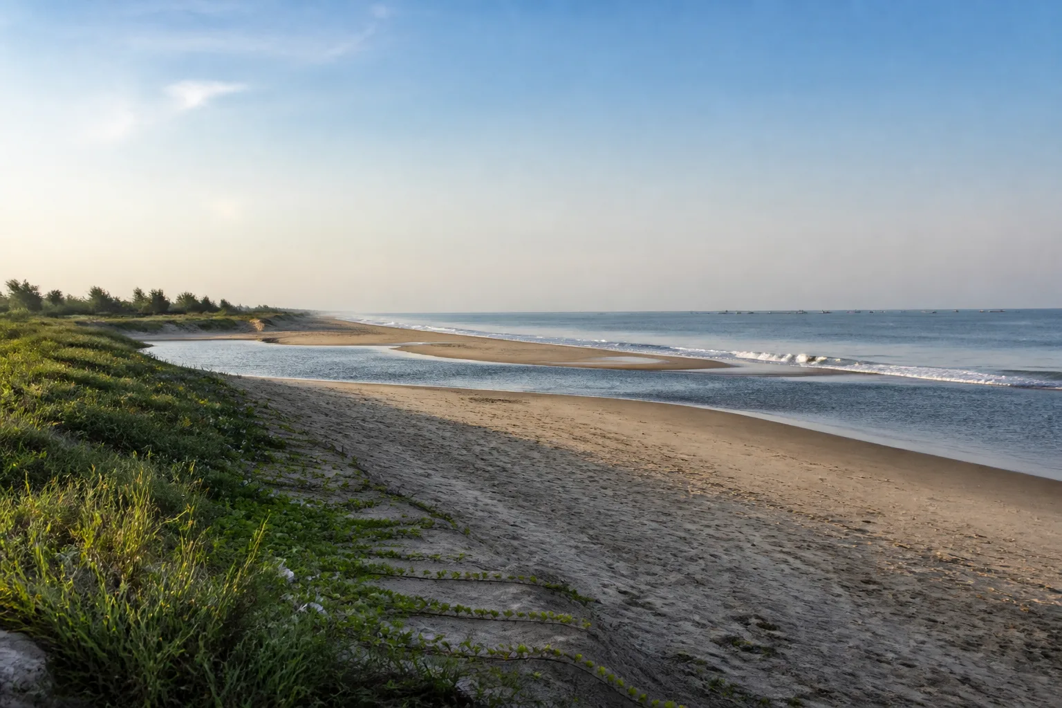 Sandy Tamil Nadu coast with low dunes, estuary water and the Bay of Bengal