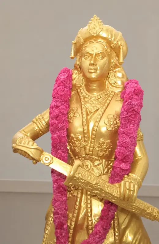 Modern memorial statue of Velu Nachiyar isolated against a neutral background